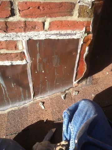 The original flashing is worn and coming off of the chimney, which means it is not watertight.