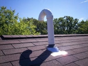 Soil pipe ridge vent on asphalt shingle roof.