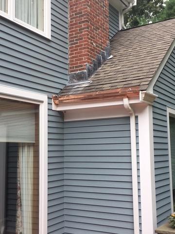 The built-in copper gutter has been installed, leaving the last step of replacing the shingles.