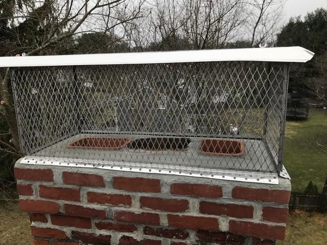 Re-pointed chimney with a brand new crown and stainless steel chimney cap
