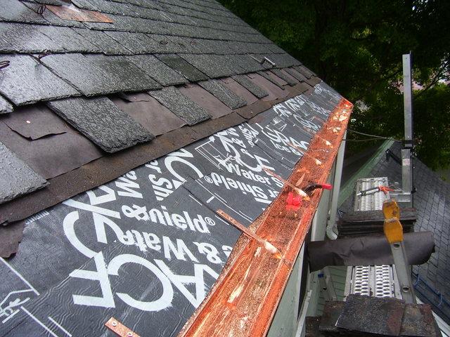 Installing copper gutters onto fascia board over ice and water shield.