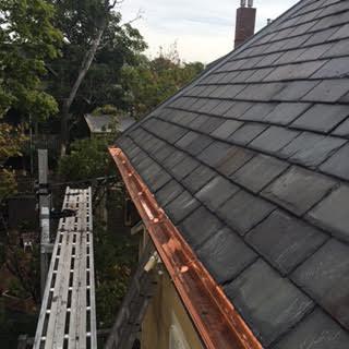 The completed project is shown here, with the gutter fully installed and the slates along the gutter line replaced.