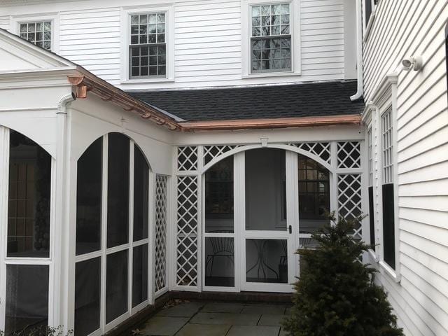 Copper gutters installed on a shingle roof in Wellesley, MA.