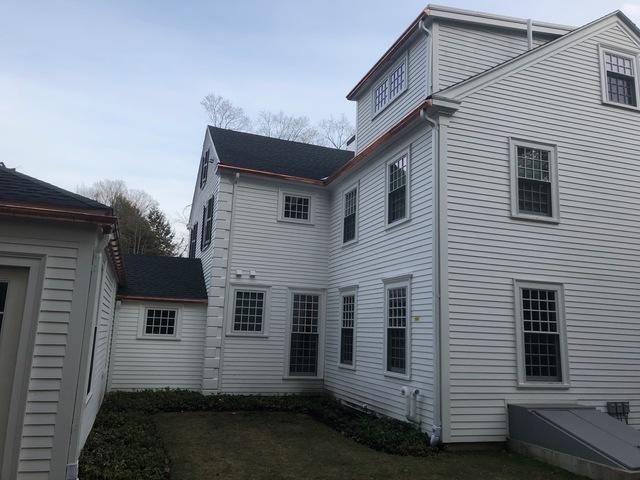 Copper gutters installed on a shingle roof in Wellesley, MA.