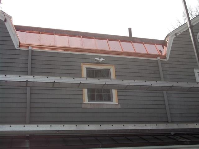 This picture clearly shows the contrast between the old gutter and the new one, with the copper panels and gutter making the roof system much more effective than it was before. Not only does this customer have beautiful new copper work to look at, but they will also be worry free when it comes to leaks.