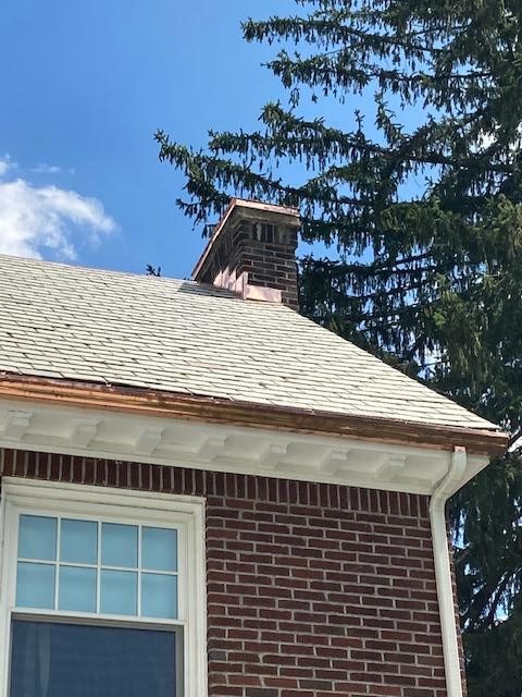 Installing brand new copper flashing onto this chimney on the home.