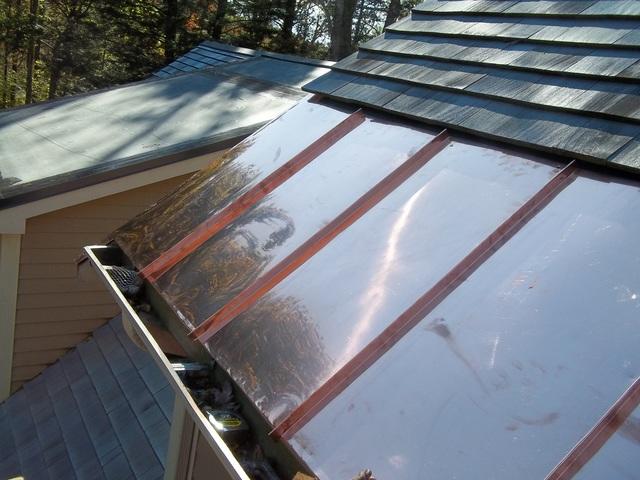 The copper panels have been fully installed and properly tied into the existing wood shingles. This new section of the roof not only looks great, but it will allow water to run into the gutters as it should, rather than penetrating and damaging the wood shingle roof.