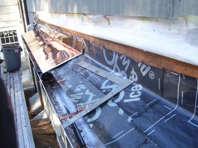 Another section of the copper ledge can be seen, with a clearer view of the ice & water shield, showing how it helps water flow into the gutters.