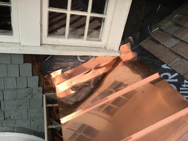 Copper flashing prevents water from entering the home through cracks where the roof and walls meet.

