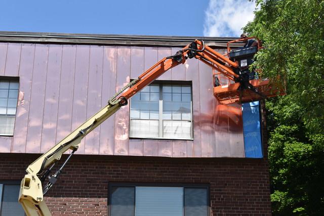 Installing copper panels on a three-story condo unit.

