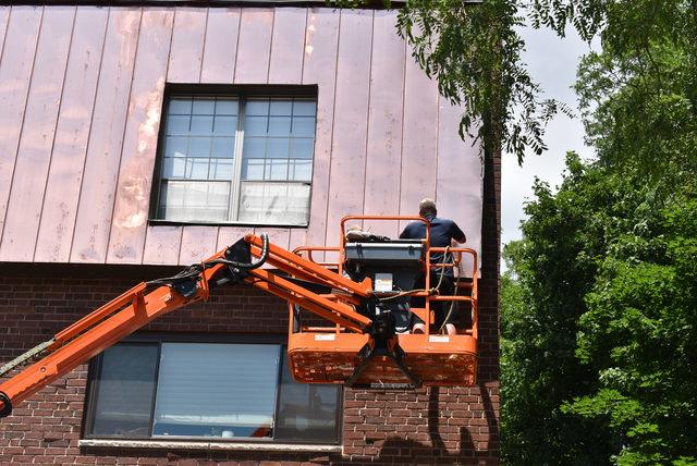 Installing copper panels on a three-story condo unit.

