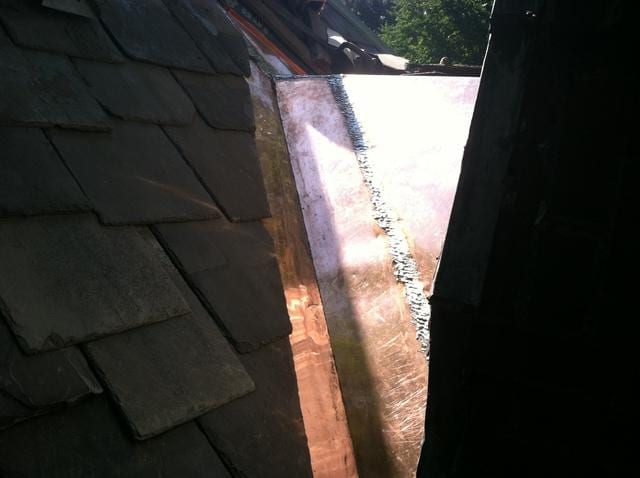 After installing the copper roof, we returned the slate shingles to their original place!

