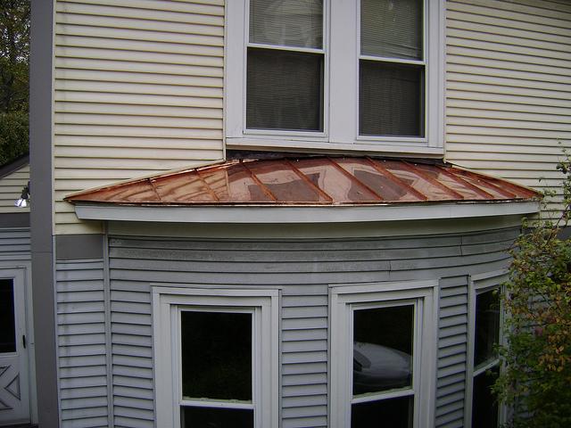 A small copper roof perfectly accents these windows.