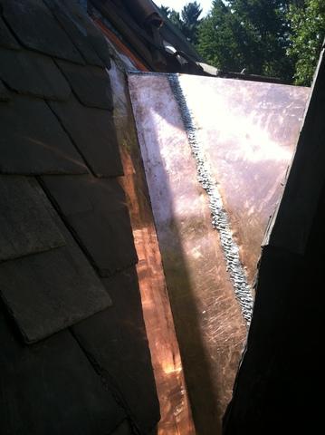 The slates have been replaced around the copper, and now this valley will last for years and the homeowners won't have to worry about a leak any time soon.