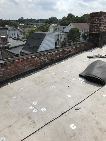 The insulation boards are laid out and fastened down. The pattern we use to nail them down makes the roof's underlayments as secure and watertight as possible.