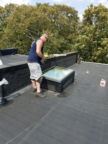 With the rubber roof now installed, our crew reattaches the skylight. All that's left for this project is a few finishing touches and a little cleanup.