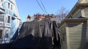 Asphalt roof being torn off for a roof replacement.