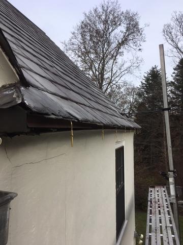 The gutter hangers have all been installed, so the next step is for our crew to attach the custom copper gutters.