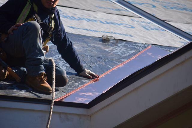Installing asphalt shingles on top of ice and water shield.


