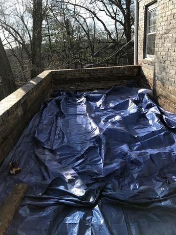 Here you can see the deck tarped off to protect it while we prepare to install the copper. The wear and tear beginning to show on the bricks is part of the reason custom copper will be used moving forward.