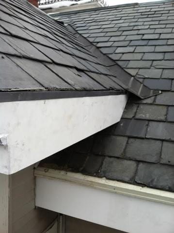 Our crew completes the job by making sure that the new carpentry work ties in seamlessly to the beautiful slate roof.