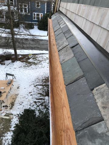 Wood gutters on a slate roof.
