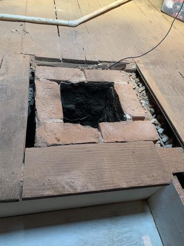 Continued process of rebuilding the chimney inside the attic.