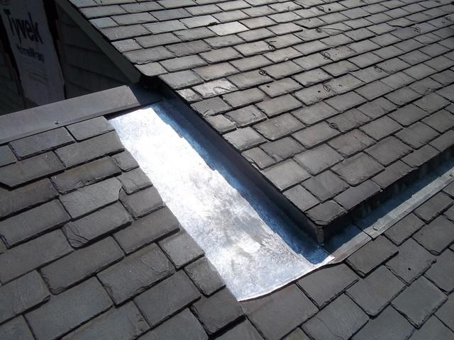 Our crew has replaced the slates on this section of the roof, and installed metal as well. The metal is installed where two sections of the roof meet, making sure there are no gaps where water could elak in.