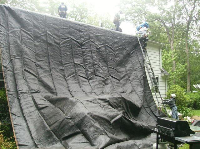 Before removing the existing roof, our crew sets up tarps which run from the roof to the ground. This ensures that any material being removed from the roof won't damage the side of the house as it is thrown down.
