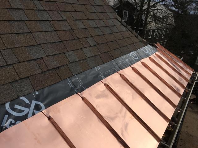 The new copper panels have been installed along the edge of the roof. All that's left to complete this project is replacing the last row of shingles.