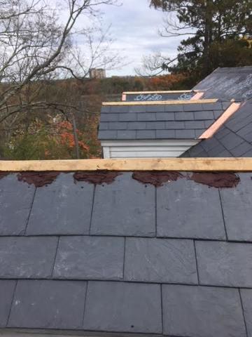Red cement and wood are used to prep the dormers for the copper, giving the copper a foundation along with the slates.