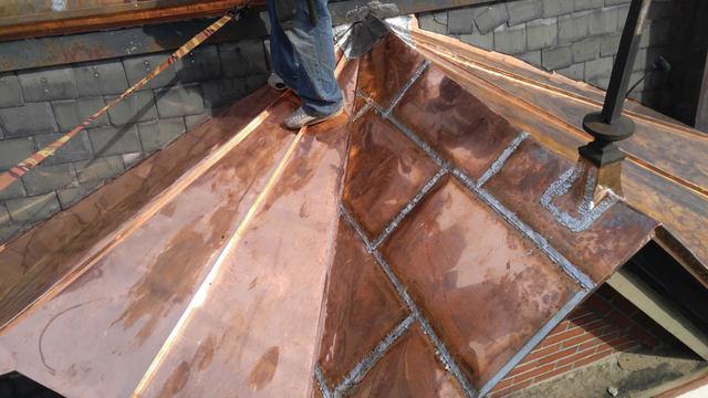 Our crew has installed the copper panels, and they look great along with the slates behind them.