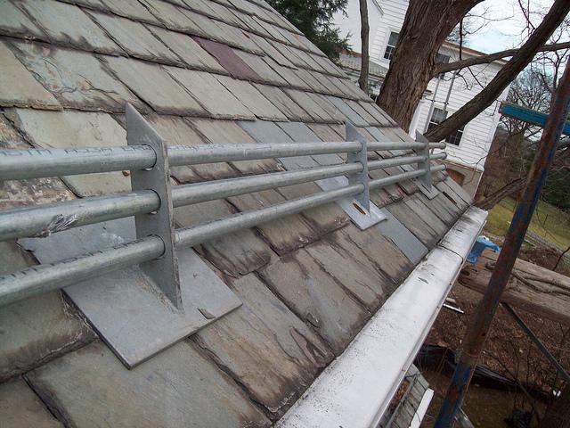 We installed ice rails onto the slate roof to help stagnate the falling snow and ice and reduce the danger.