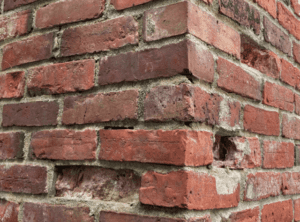 Missing bricks from a chimney needing repair.