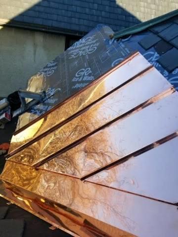 You can see the ice & water shield that is applied to the roof before the copper panels, creating a watertight barrier to build a strong foundation for the roof.