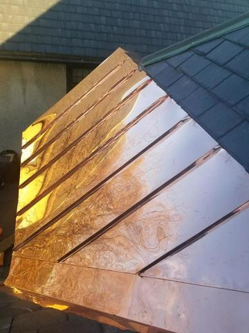 The copper panels have been fully installed and tied into the shingle roof. They not only look beautiful, but they'll solve the leak issue the Church had been having as well.