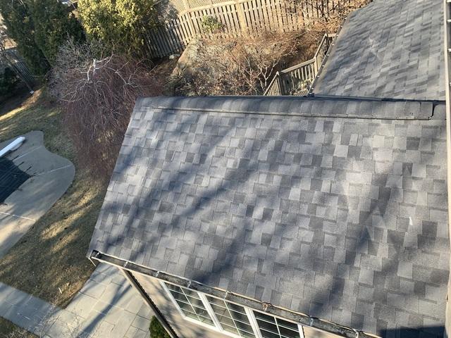 Installed shingle roof with ridge ventilation.