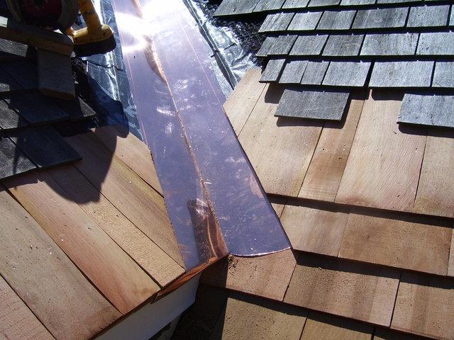 Installing wood shingles around copper valley.