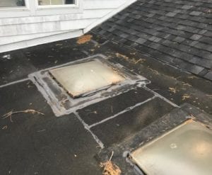 Deteriorating skylight on a flat membrane roof.