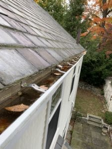 Leaves and flooding in clogged gutters. 