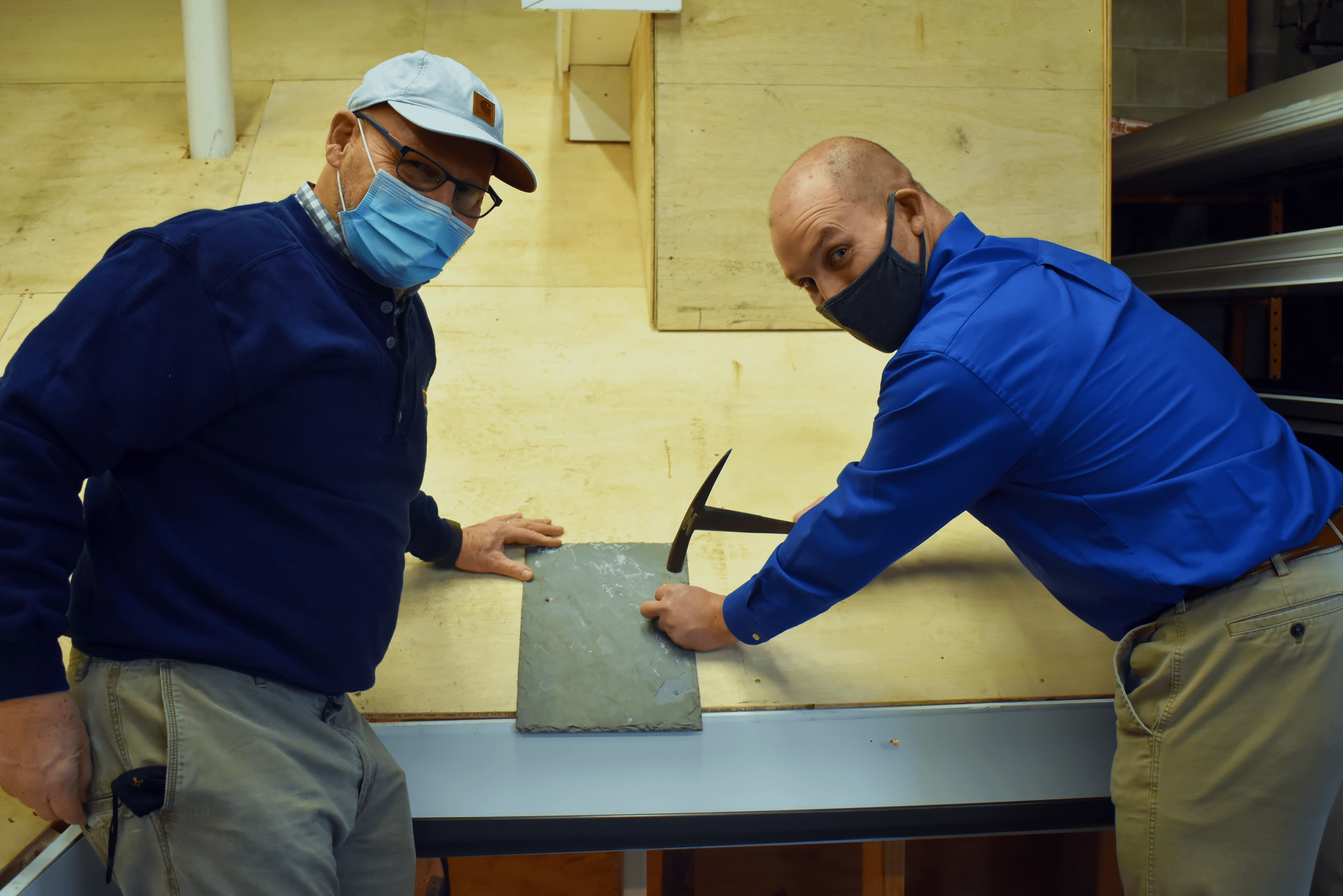Jerry and Jake Sprague laying the first slate shingle on our brand new mock training roof.