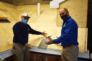 Jerry and Jake Sprague Laying the first slate shingle on our brand new mock training roof.